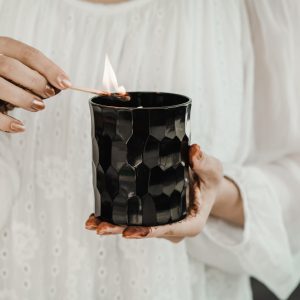 AND collection lighting the full size candle in hand