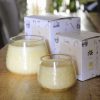 Hand-poured Naive Neroli small and large glass jars made from palm wax with Palm Lights boxes.
