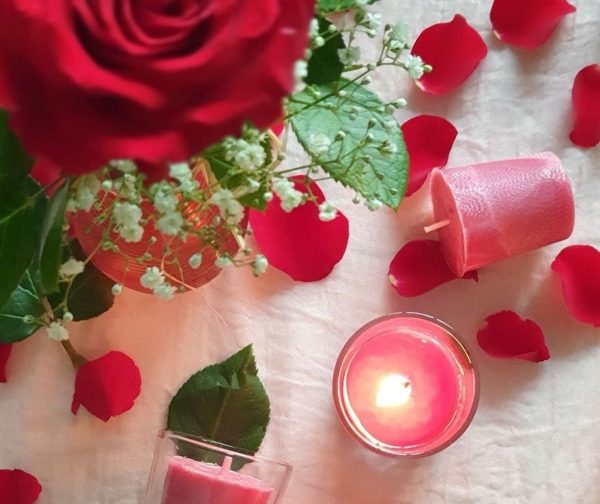 PalmLights pink votive candles with soft glow and rose petals creating a calm meditation space in UAE