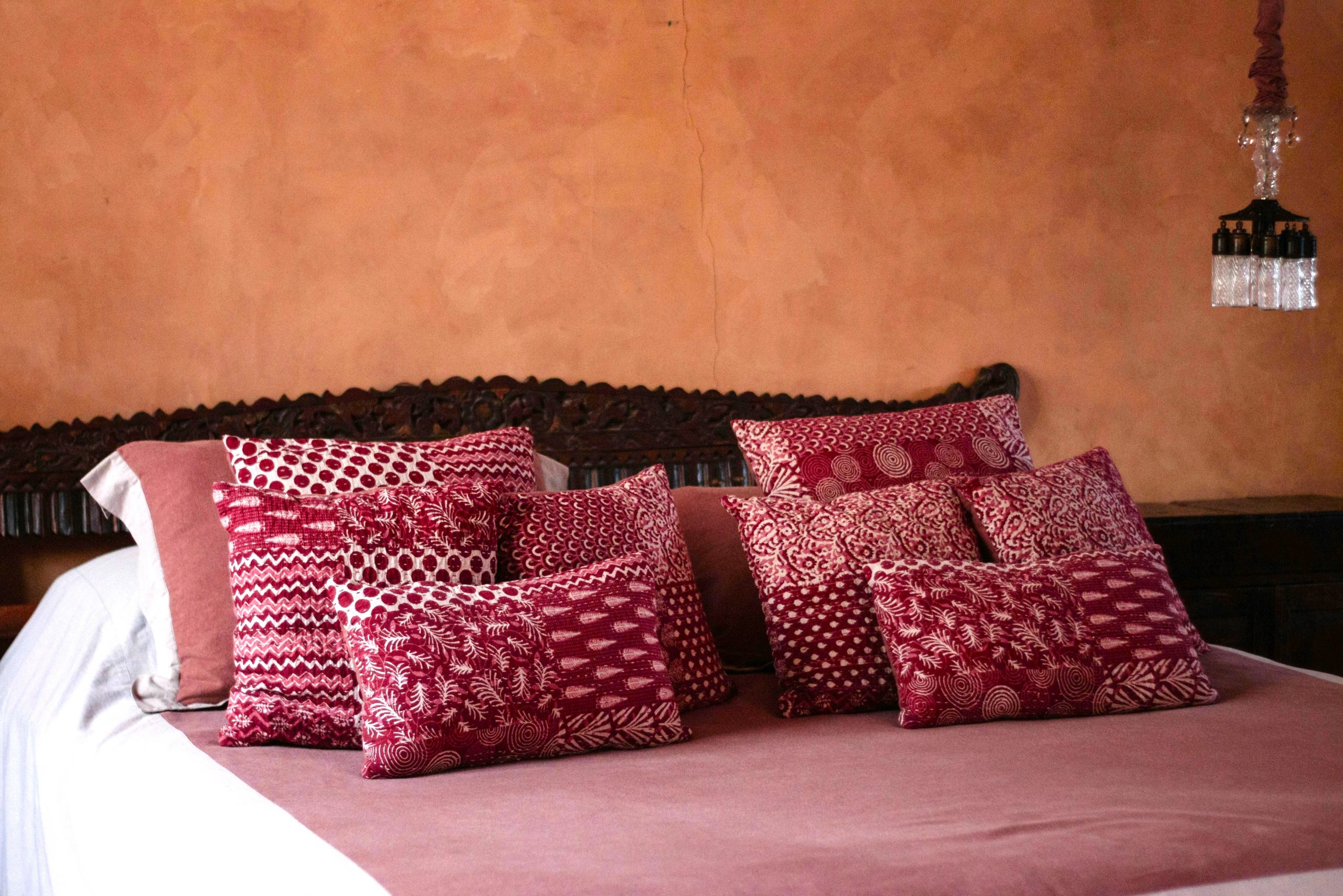Red cushions and bed linen — incorporating red into your space for Root Chakra balance