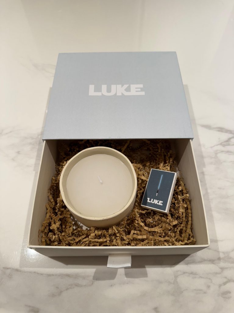 Luxury candle gift box featuring a branded matchbox and handcrafted candle presented in premium packaging.