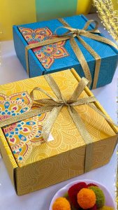 Elegant candle gift set packaging with decorative festive gift boxes tied with golden ribbons for special occasions.