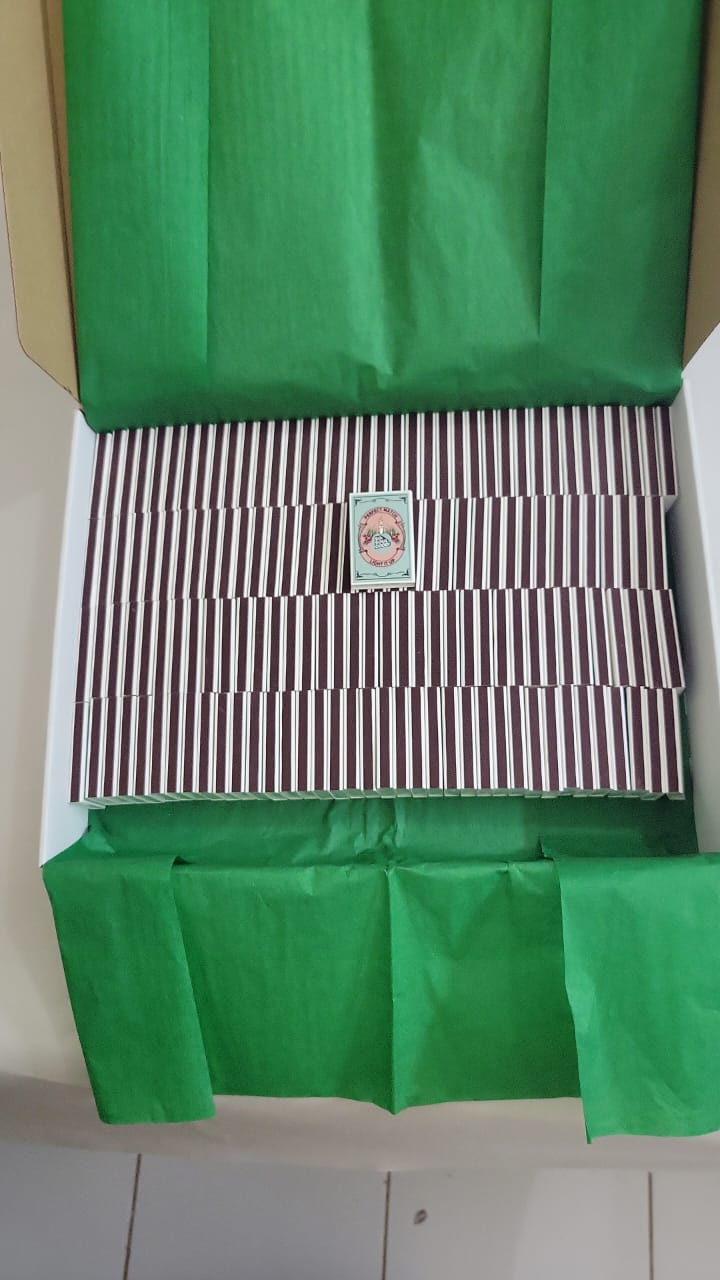 Bulk custom matchboxes neatly packed in a gift box with tissue paper for private label branding and event favors.