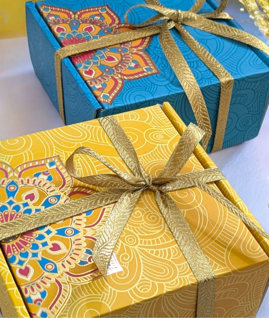 Elegant candle gift set packaging with decorative festive gift boxes tied with golden ribbons for special occasions.