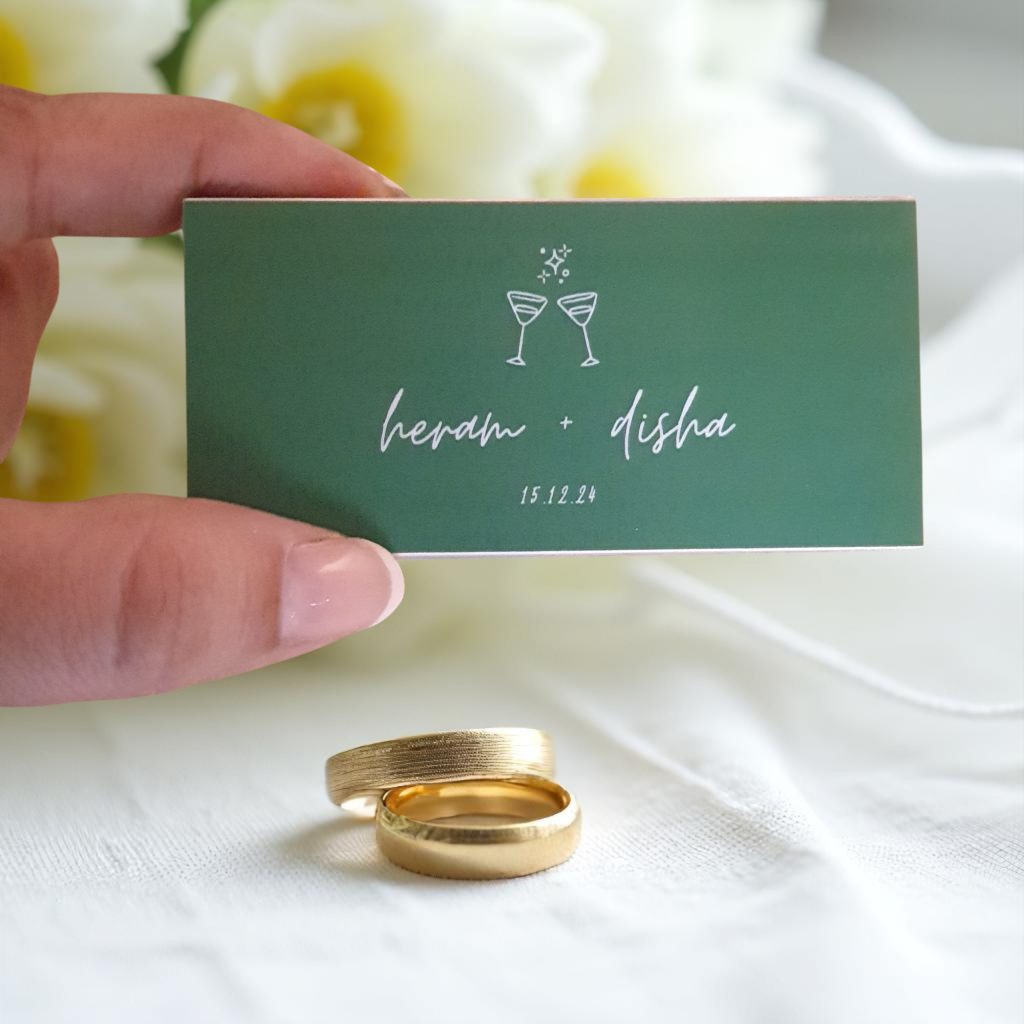 Personalized wedding matchbox featuring the couple's names and wedding date displayed beside wedding rings.