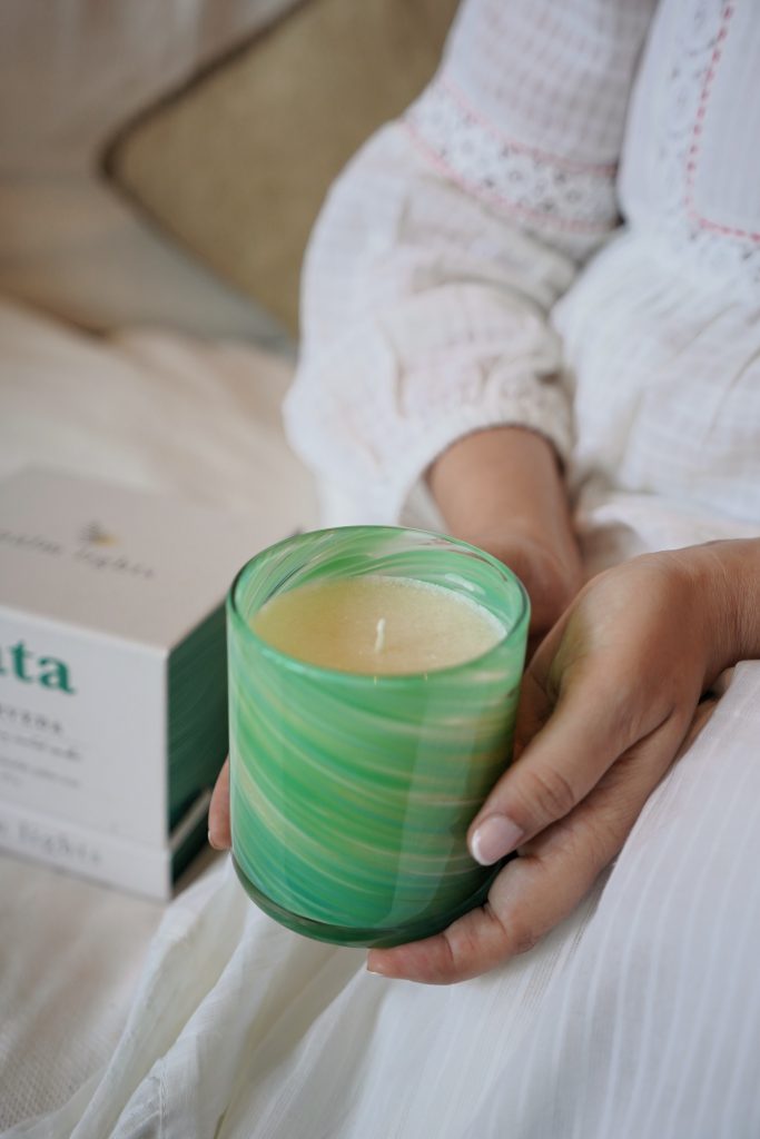 Hands holding a Palm Lights Vata Ayurveda candle
