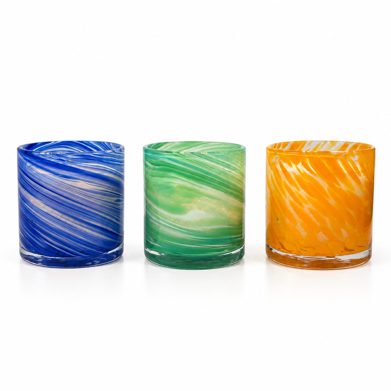 Three Palm Lights Ayurveda candles side by side in amber glass jars, white background